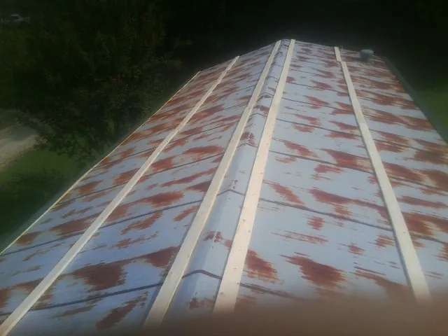 Rusted metal roof panels with new wood purlins before replacement — Storm Damage Roof Repair in Sheffield by Roofing Brothers